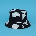 Double-sided reversible bucket hat featuring a classic black and white cow print pattern - Large Cow Pattern Double-Sided