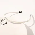 Close-up detail of double-row white pearl headband with protective black ends - Double Row Small Pearls