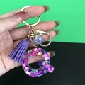 Resin initial Q keychain with purple tassel and gold hardware accessory detail - Letter Q
