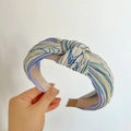 Detail view of silk-textured knotted headband featuring blue and purple linear patterns - Knot Headband / Purple