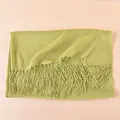 Detail of light green pashmina scarf featuring micro-wrinkle texture and soft tassel fringe - Light Green
