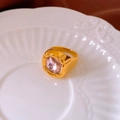 Macro shot of gold plated ring with a large square pink zircon stone on a white ceramic plate - 6# Ring - Gold - Pink