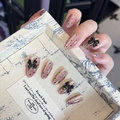 Detail of pink press-on nails with black polka dots and 3D bow charms in a vintage box - By1585 Spotted Black Butterfly / Glue Type