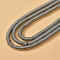 Close-up of industrial style silver spring metal coil strands on layered necklace - Approx. 350 pcs per strand / 27# Antique Silver Disc (6*1mm)