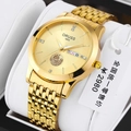 Detail view of the gold quartz watch dial with ship relief and date display window - Sailboat Gold - Nine-bead Gold Strap