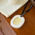 White gypsum scented tablet with yellow wax core and black ribbon on wood - Ebony Oud - Oval