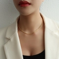 Minimalist gold starry chain necklace set worn by a model in a professional studio setting - Gold Necklace