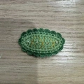 Green crochet oval hair clip with gold embroidery and white beads on wood background - Christmas Series - Green Oval