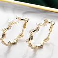 Elegant gold earrings with wave design and rectangular clear zircon crystals in detail - Gold Wave Hoop Inlaid Rectangular Diamond Earrings(E2768-1)