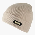Detail of knitted beige beanie showing the metallic Classic Fashion brand tag - Beige