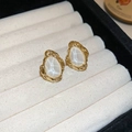 Macro detail of vintage gold earrings with milky white stones and lava texture - Water Drop Stud / White