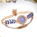 Detail of luxury rose gold watch with purple dial, diamond bezel and leaf crystal bracelet - Blue