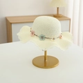 Detail of cream-white woven straw hat with delicate floral chain and wavy scalloped edge - Straw Hat / Straw Hat - Milk White