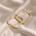 Detail of matte gold square earrings resting on luxurious draped silk fabric surface - 925 Silver Needle / Square Hoop Style / Matte Gold