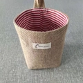 Hanging jute storage bag with red striped cotton lining and giraffe label detail - Red Stripe