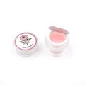 Detailed macro view of 5g pink eyelash glue remover gel in a clear jar and foil seal - Jasmine
