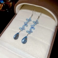 Detail of blue layered butterfly earrings with a teardrop crystal pendant in a jewelry box - Ear Hook Butterfly Water Drop Pendant Style / Sky Blue