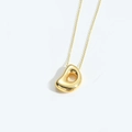 Elegant gold necklace featuring a polished irregular bean pendant on a minimalist chain - Letter D