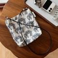 Dettaglio macro della borsa a tracolla in tela crema con ricamo leopardo blu e targhetta semplice - Beige Con Ricamo Leopardato