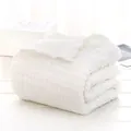 Folded white 6-layer cotton gauze baby blanket with soft crinkle texture and puffy finish - Pure White