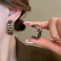 Close-up of leopard print resin earrings worn by a model for a chic fall fashion style - Brown Black C-Shape (11)