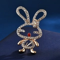 Golden rabbit brooch with sparkling crystals and a red rhinestone nose on navy fabric - Red Lip Rabbit