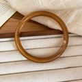 Vue détaillée d'une bague en résine ambrée translucide aux textures nuageuses naturelles - Bracelet (Éco-Marron)