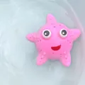 Pink cartoon starfish bath toy floating on water, soft texture with sensory bumps - Pink Bath Starfish Toy