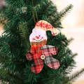Plaid snowman Christmas ornament with red scarf and wooden button hanging on a tree - Checkered Cloth Snowman