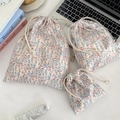 Three-piece floral drawstring storage bags for cosmetics and travel in diverse sizes - Wind Blowing Wheat