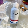Cute light blue toothpaste plush keychain with smiling face for kids' backpacks - Toothpaste
