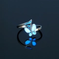 Detailed close-up of a 304 stainless steel glowing butterfly ring with blue luminous wings - US 8 / NY813 Round Butterfly