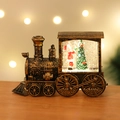 Macro shot of bronze vintage Christmas train snow globe with Santa and warm bokeh lights - Standard Bronze Kids Train (Battery Included)