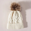 Detailed macro view of cream knit winter hat featuring chunky cable stitch and faux fur pom - One Size / White