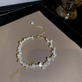 Close-up of irregular freshwater pearls and gold adjustable chain on beige leather - 1# Irregular Pearl Bracelet