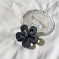 Elegant matte black flower hair claw clip displayed on a decorative shell tray - Matte Black
