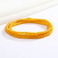 Close-up of a double-layered yellow seed bead waist chain on a soft white fabric background - 80cm / Yellow