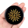 Black obsidian stone disc with golden sun and eye engravings for healing energy - Obsidian Sun Style