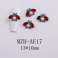 Detailed macro view of a 13x10mm beetle nail charm with red crystals and a white pearl - Pearl Beetle (AE17)
