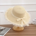 Beige straw sun hat featuring delicate lace trim and a bow on a wooden stand - Lace Small Knot Beige