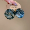 Close-up of green marble texture acrylic round stud earrings on a display card - Round Marble Texture (Silver Pin-Gold-Green-Coffee)