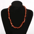 Macro view of multi-layered natural red stone necklace on a black velvet display stand - Red Brown/Red Jasper