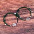 Detail of tree of life charm and heart magnetic clasp on dark green woven bracelets - Dark Green Pair