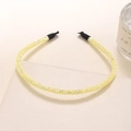 Detailed view of a slim yellow glitter headband with sparkly sequins and black end tips - Yellow