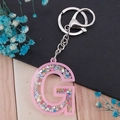 Pink glittery acrylic letter G keychain accessory with silver metal clasp for bags - Letter G