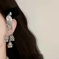 Elegant vintage silver tassel earrings with ethnic pendants shown on model's ear - Black Velvet Silver Tassel BB Clip