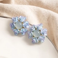 Elegant floral stud earrings in blue-purple gradient resin on white ceramic tray - Blue