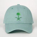 Close-up of embroidered green palm tree and crossed swords on a light blue cotton cap - Aqua Green
