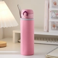 Pink insulated water bottle with matching sleeve and grey lanyard on a desk - Pink
