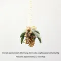 Golden pinecone Christmas ornament with bells and green pine needles on white ribbon - Gold Pinecone B